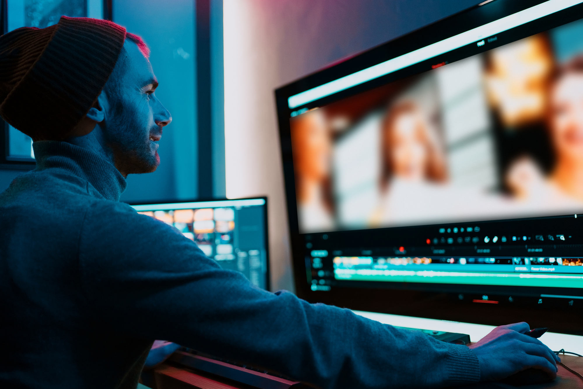 Male Video Editor Working on His Personal Computer with Big Display